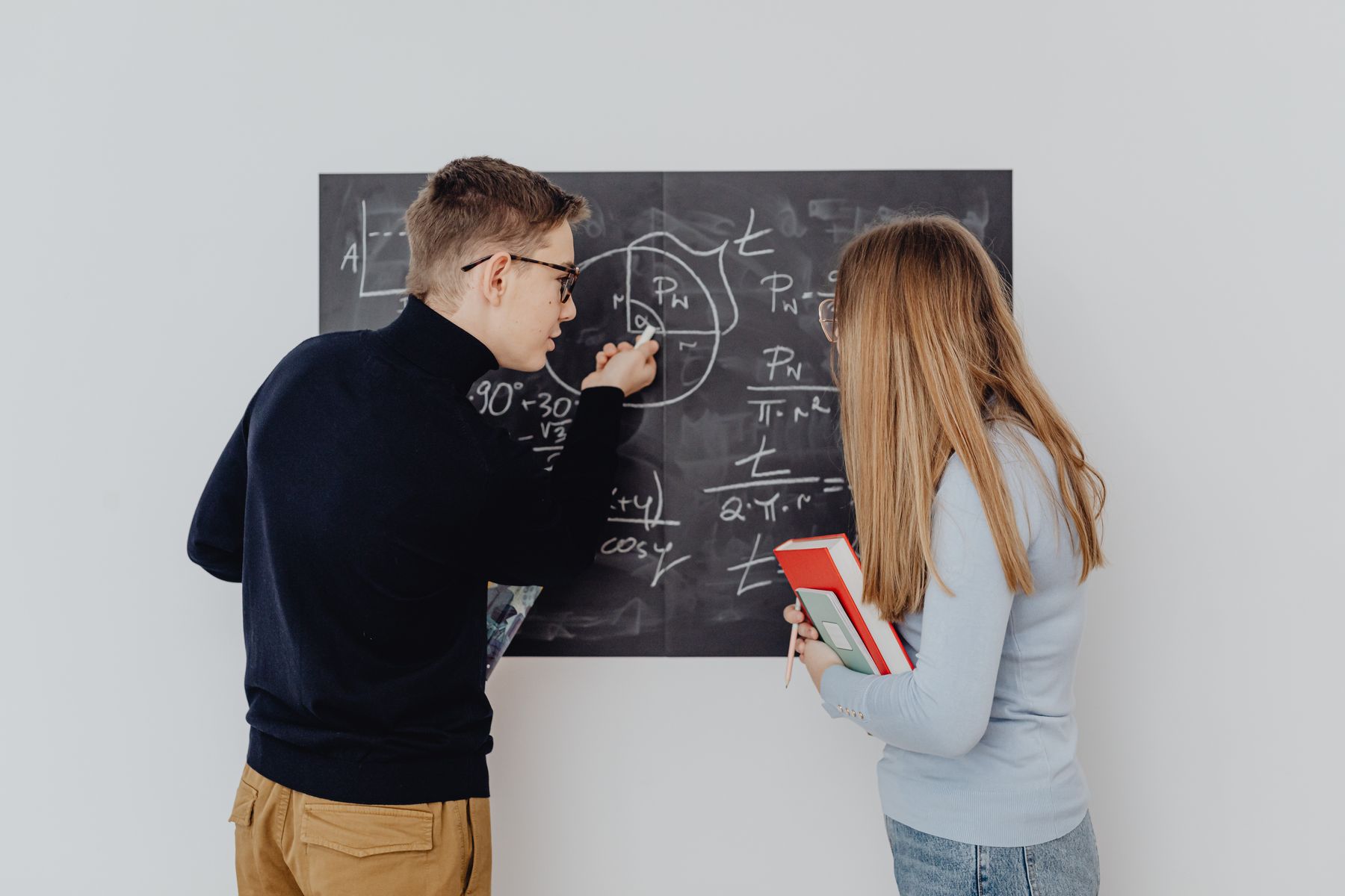 Two students working through math equations together